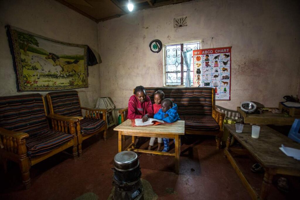 A family in Kenya utilizes solar power to study and learn 