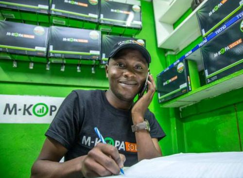 A kenyan man works for M-Kopa solar to sell renewable energy from solar panels 